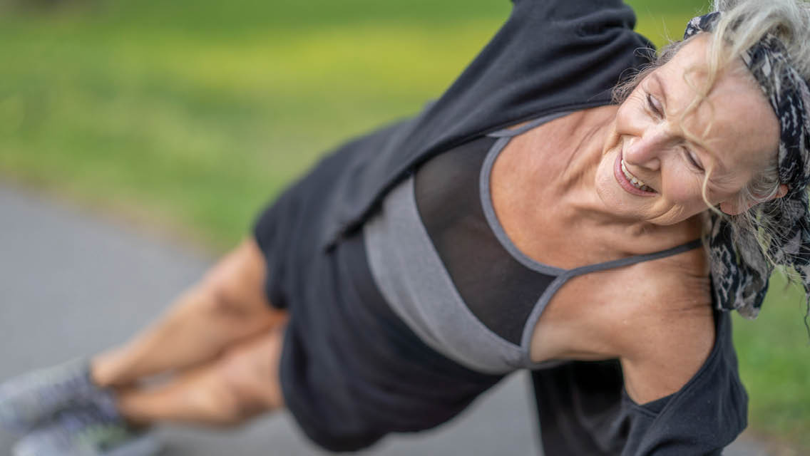 a woman holds side plank