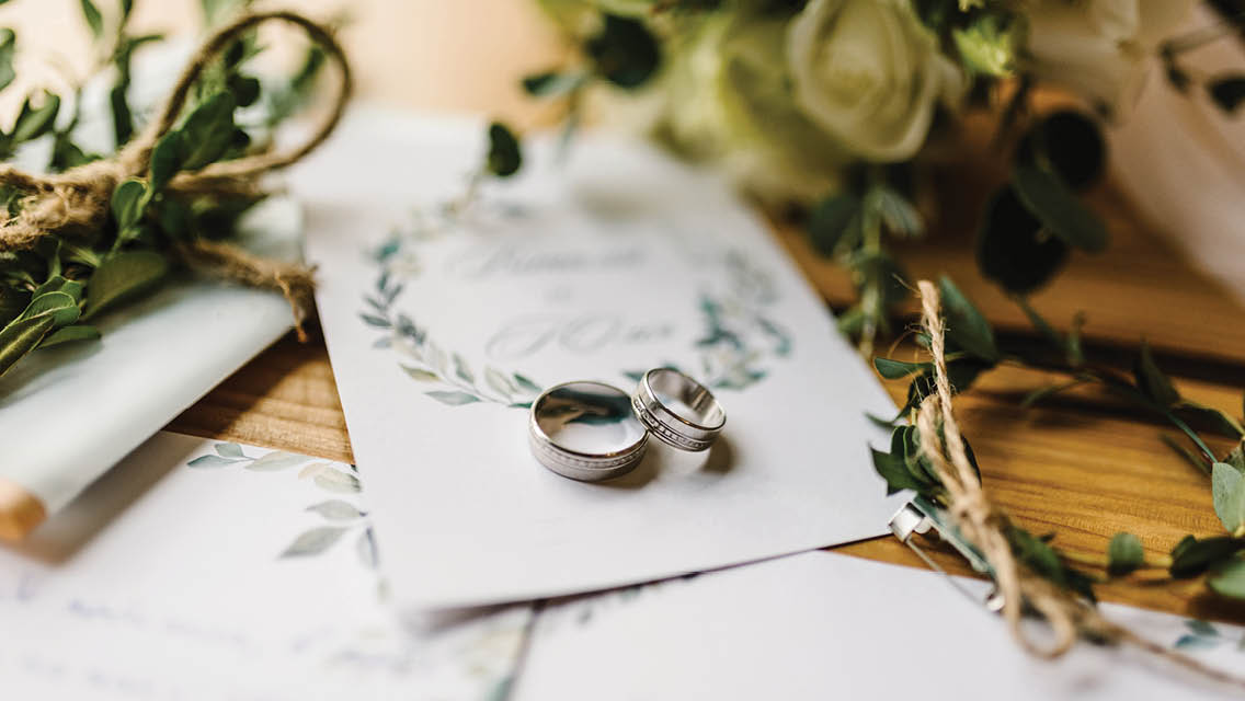 wedding rings on an invitation