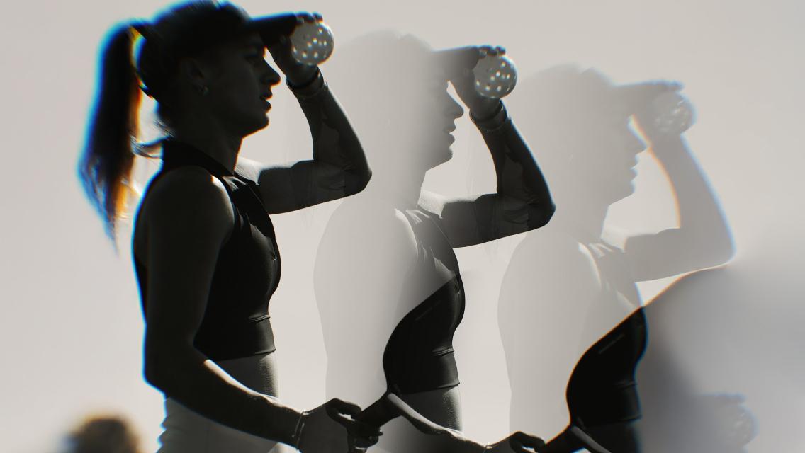 woman holding pickleball