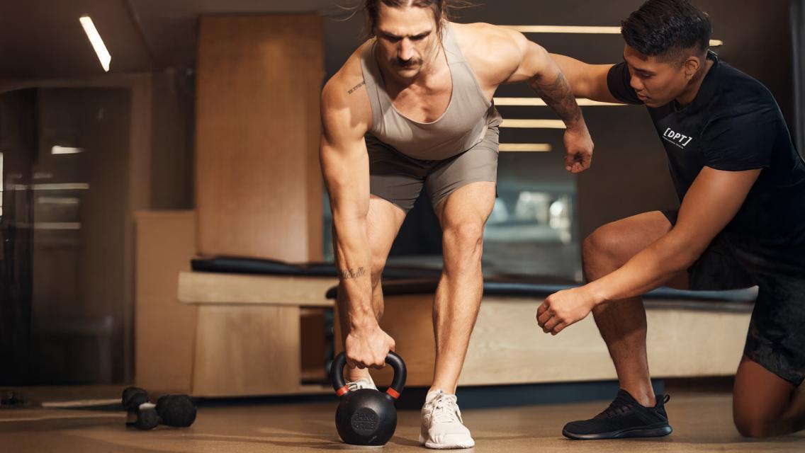 man lifting kettlebell