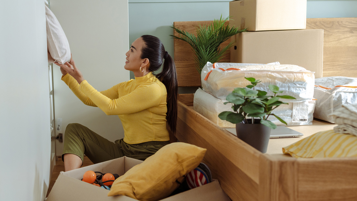 a woman organizes her bedroom