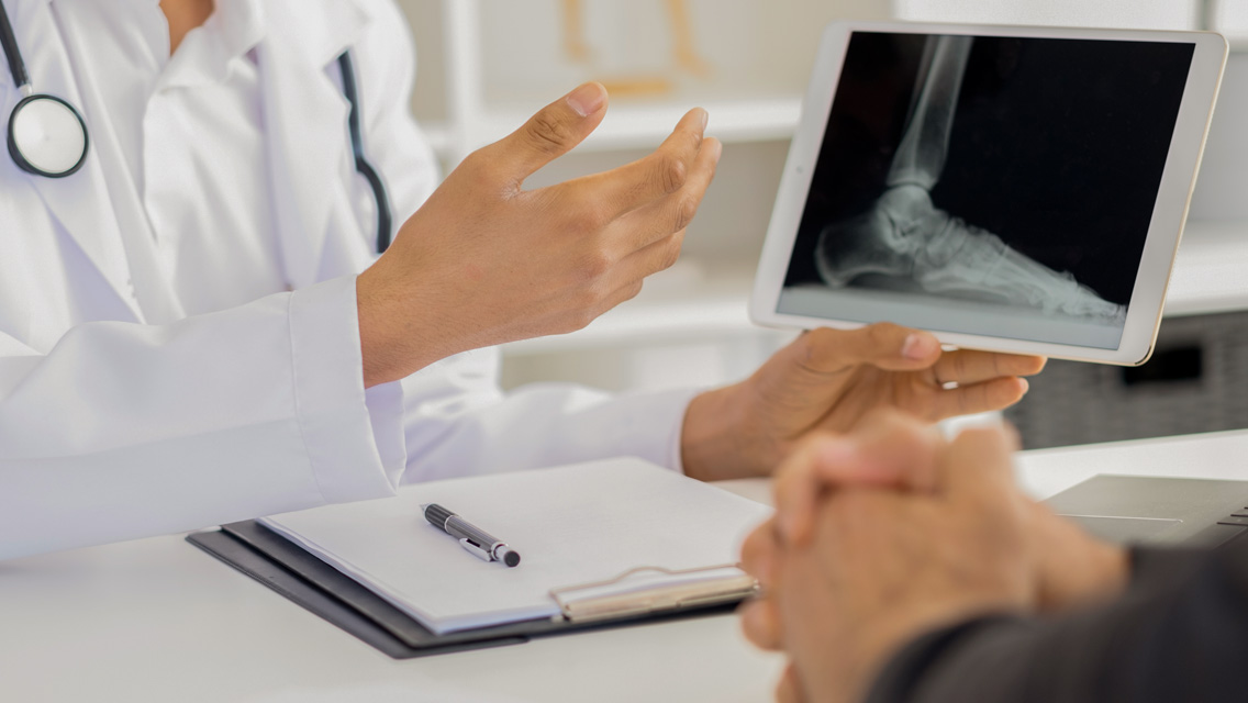 a doctor talks to a patient about his x-ray