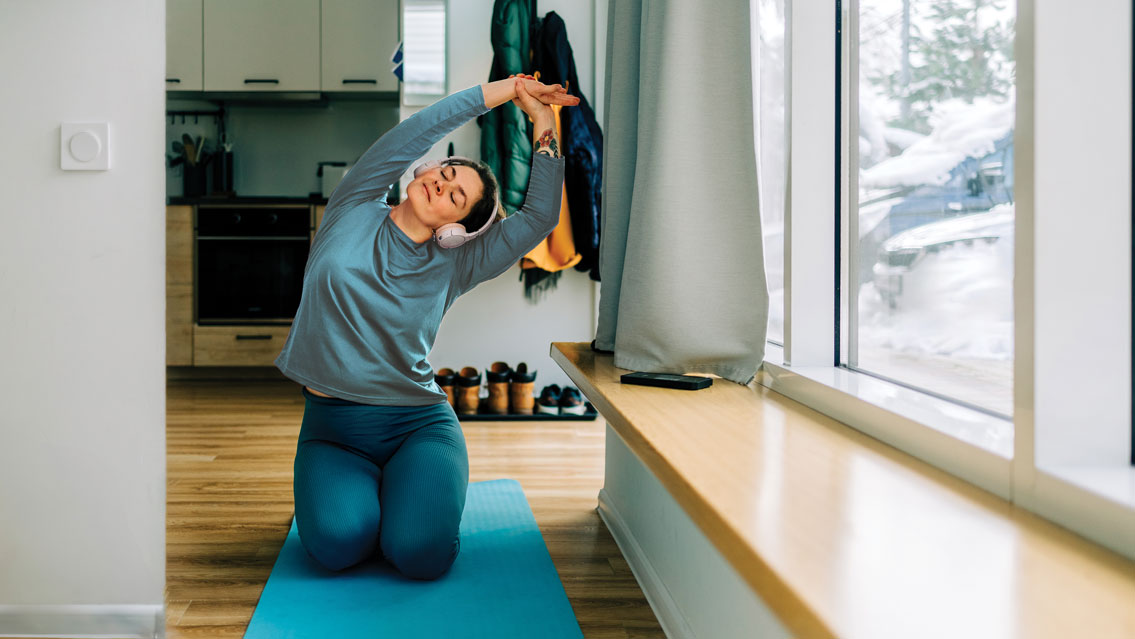 a woman stretches in her hallway