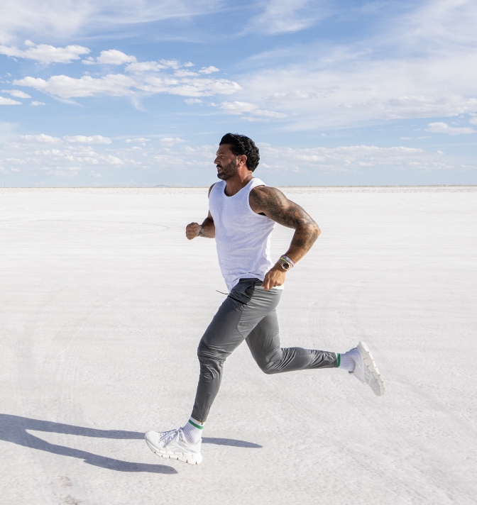 Brian Mazza running on white sand.