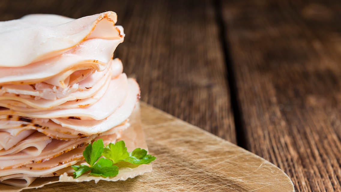 a stack of sliced deli meat