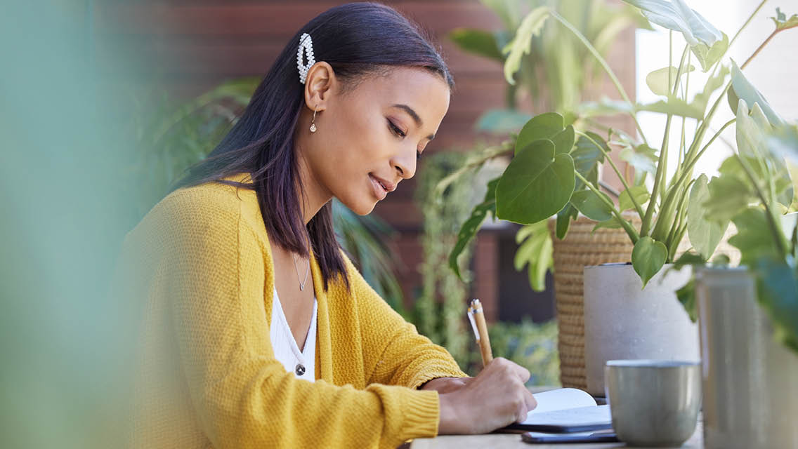 a woman writes in her journal