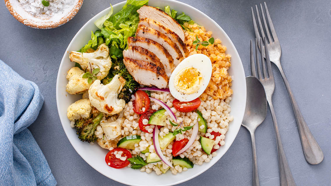 a healthy plate with whole grains, veggies and protein rich food