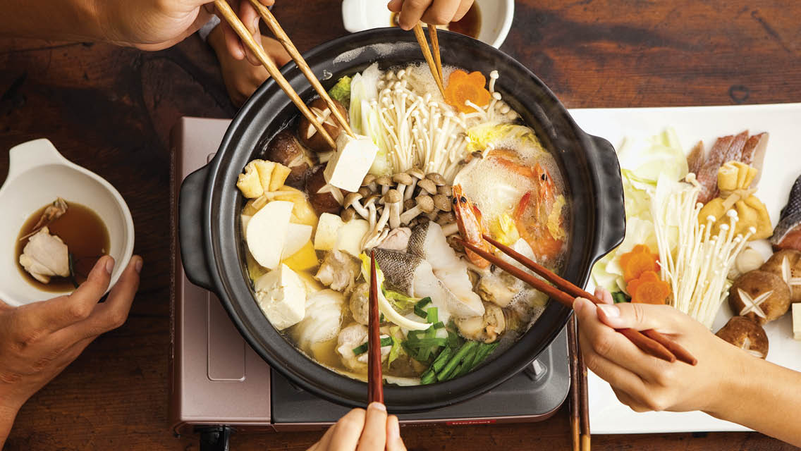 a crock pot filled with Asian food