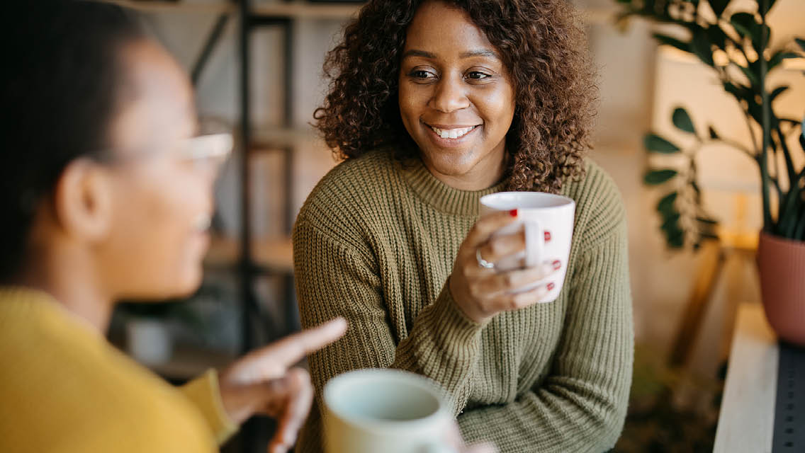 women talk while drinking tea