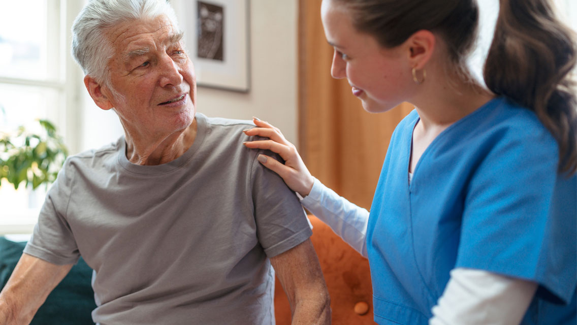 A nurse chats with a senior man