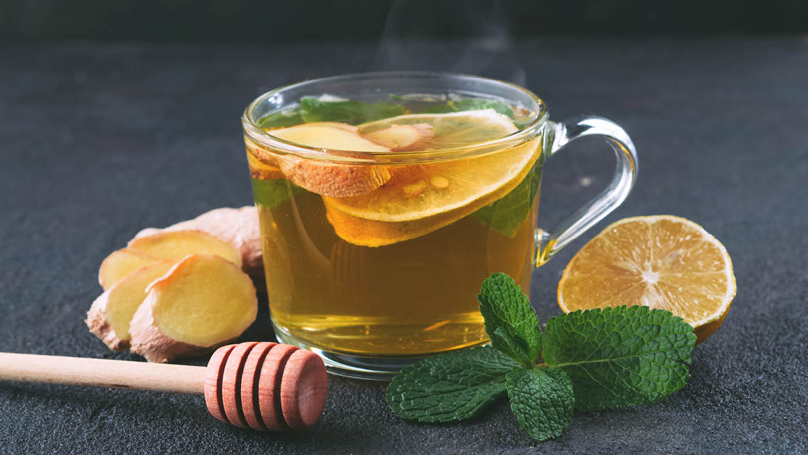 a cup of tea with ginger, lemon and honey
