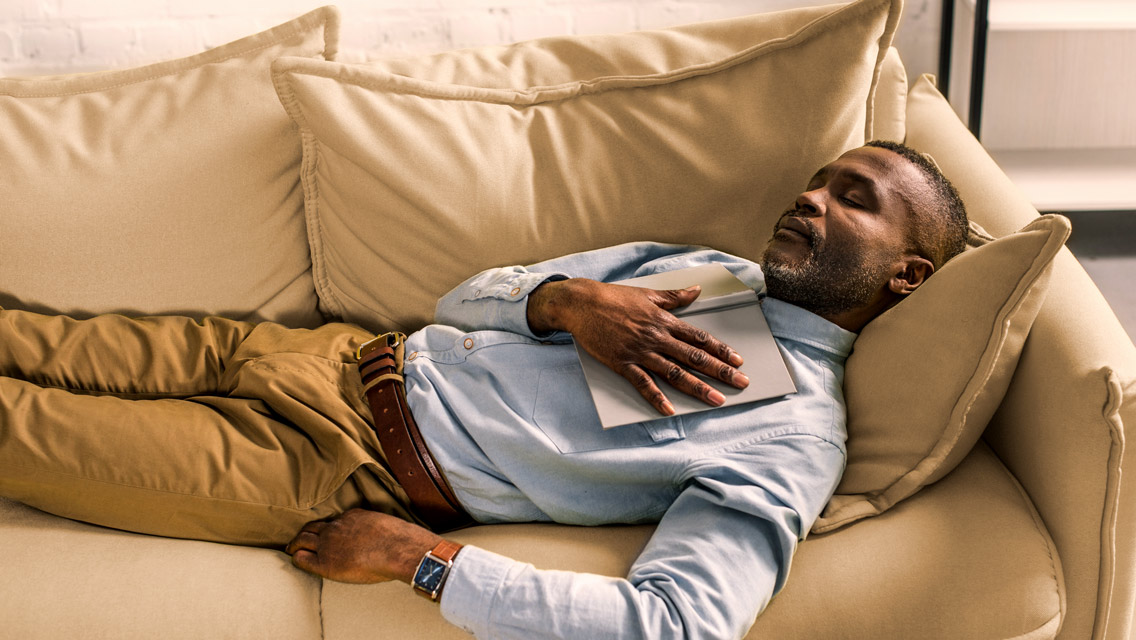 a man naps on the couch