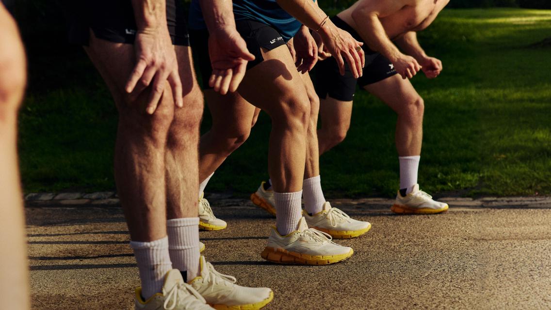 feet with running shoes on about to run a race