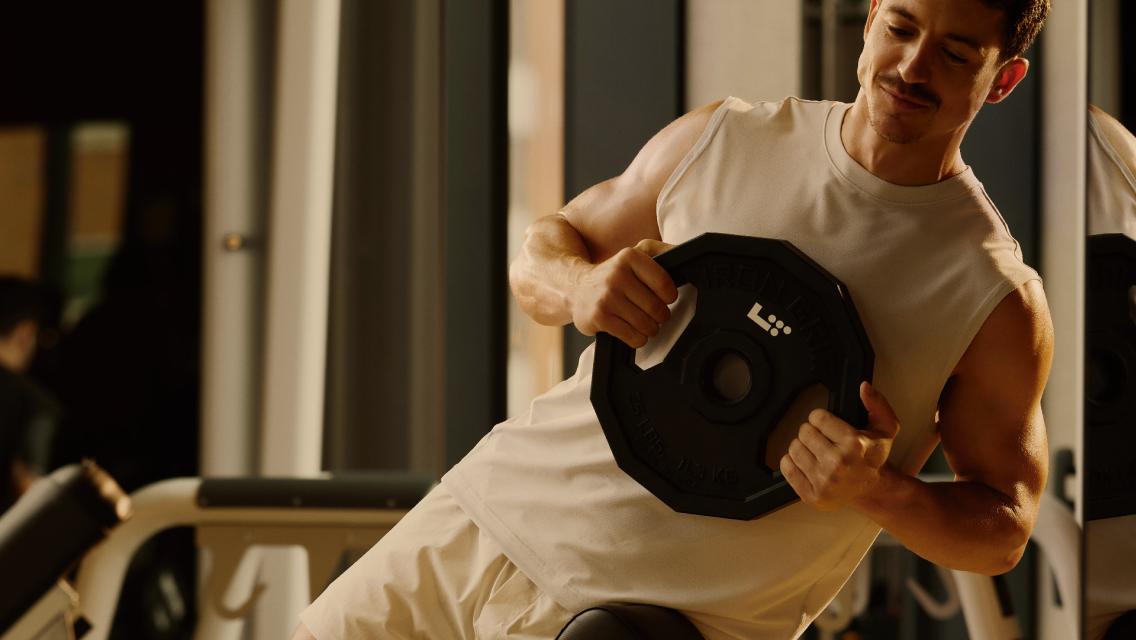 man holding weighted plate