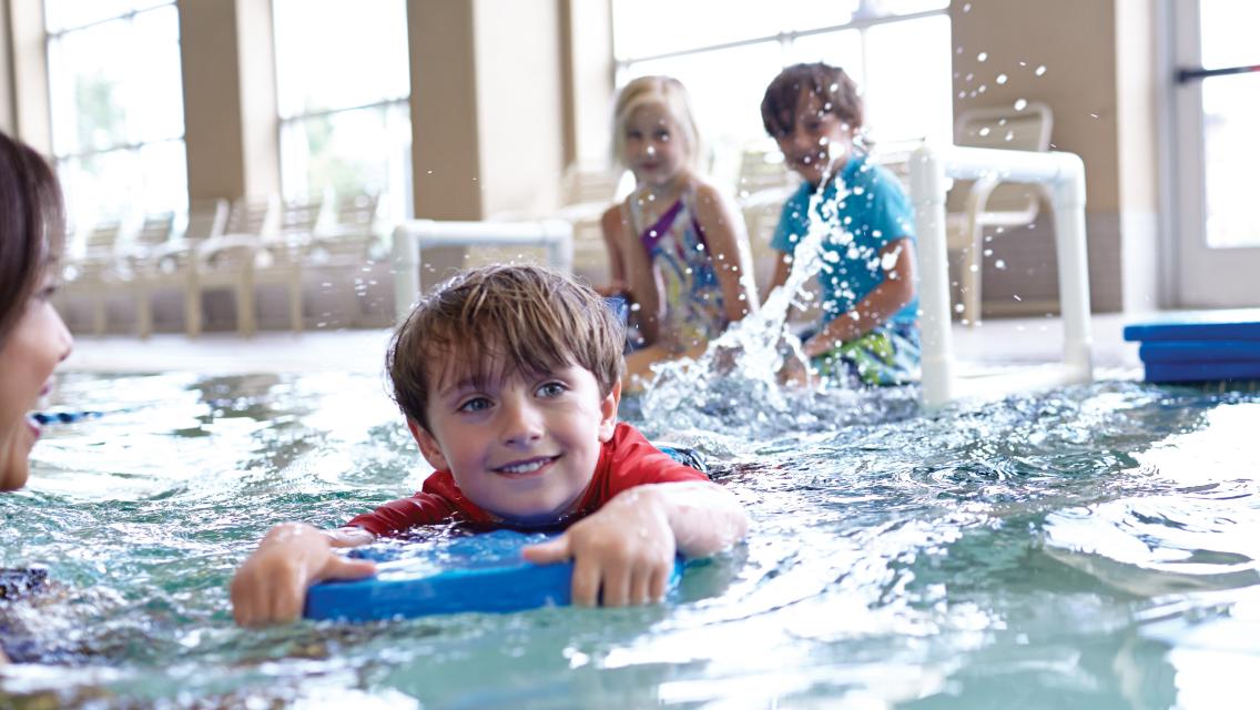 child swimming in a pool