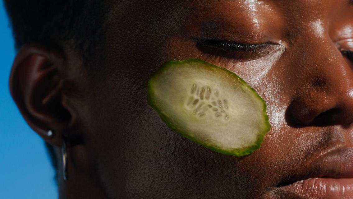 woman with cucumber on face