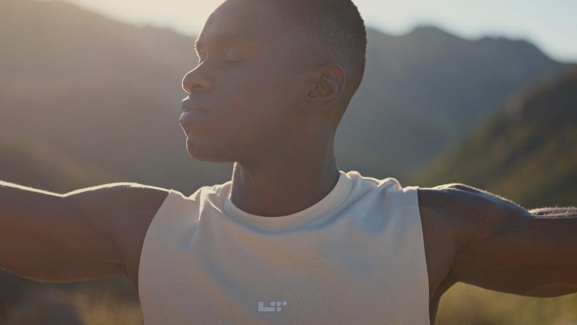 man with eyes closed standing outside