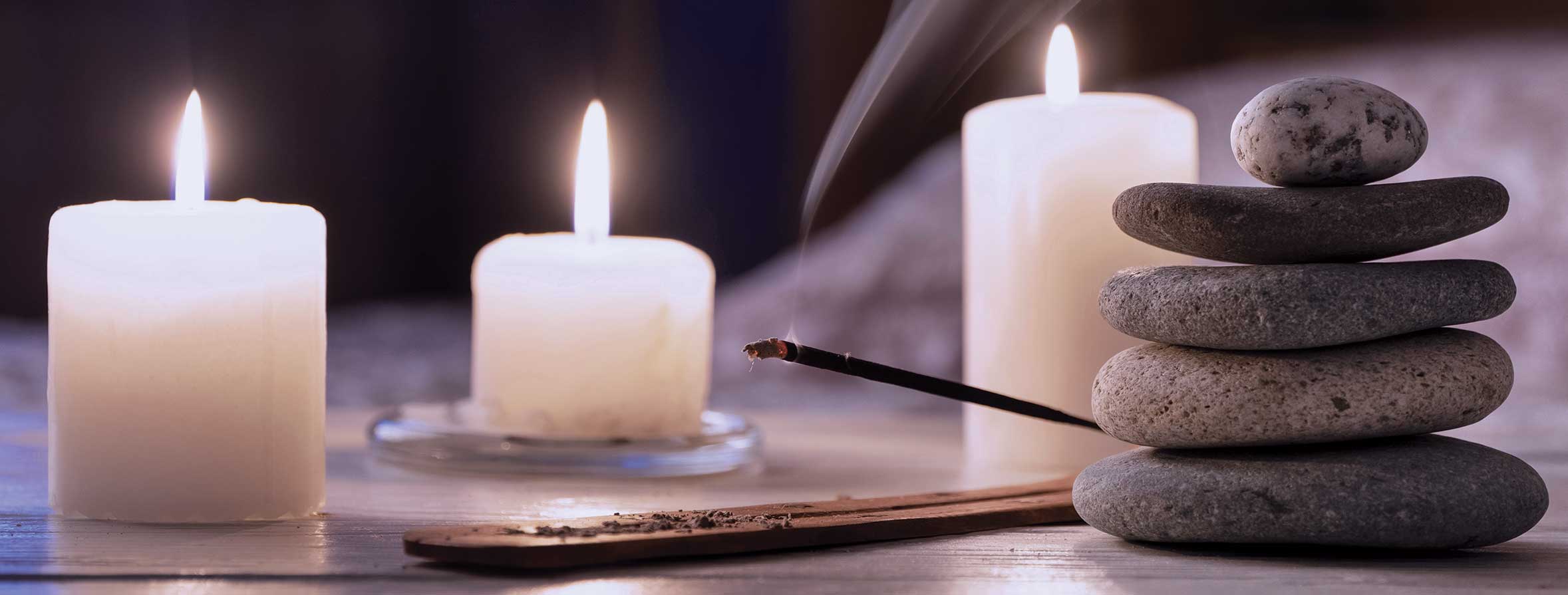 candles, incense and stacked rocks