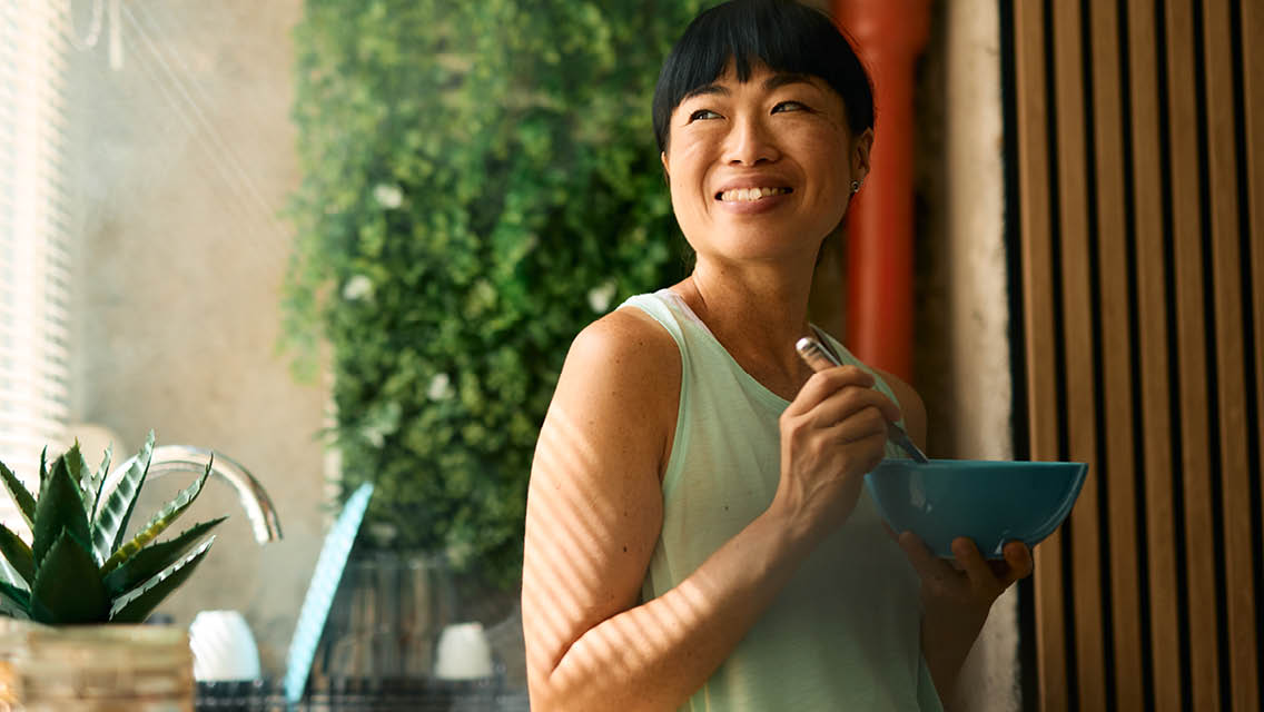 a woman smiles while eating