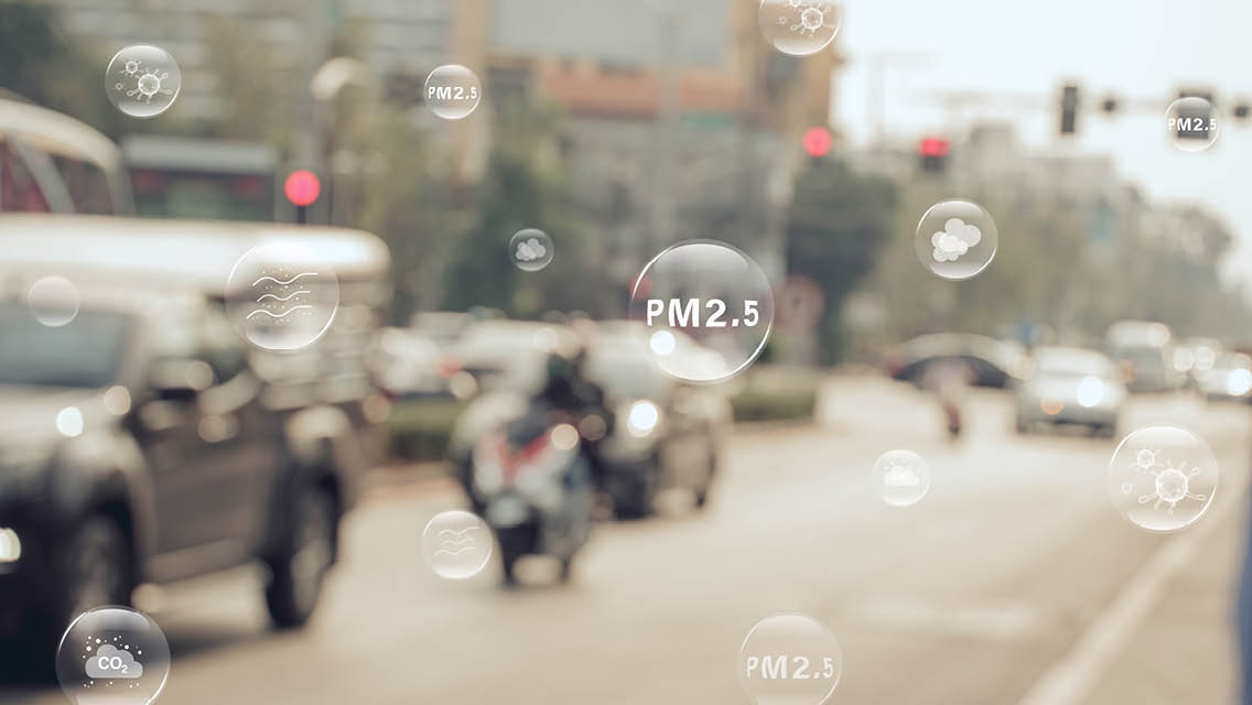 an urban street with graphics of atomic particles floating through out