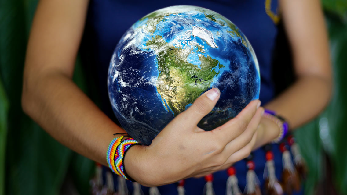 person holding globe