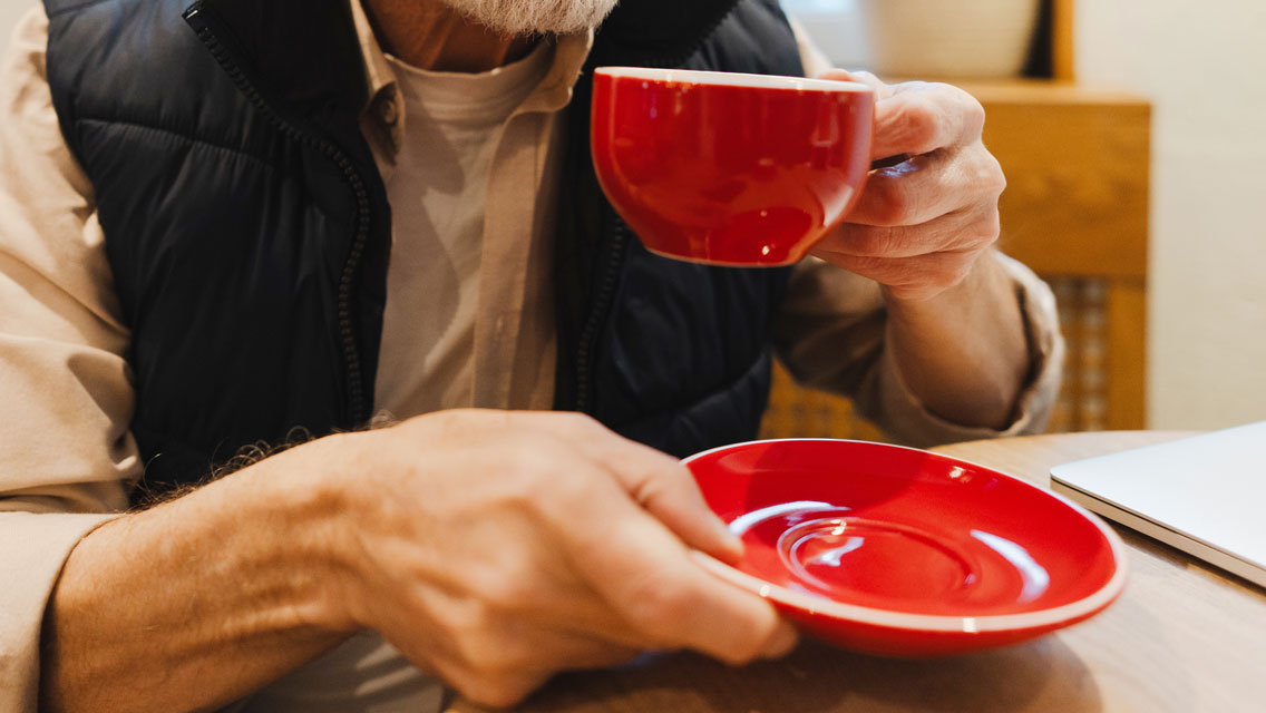 a senior man drinking coffee