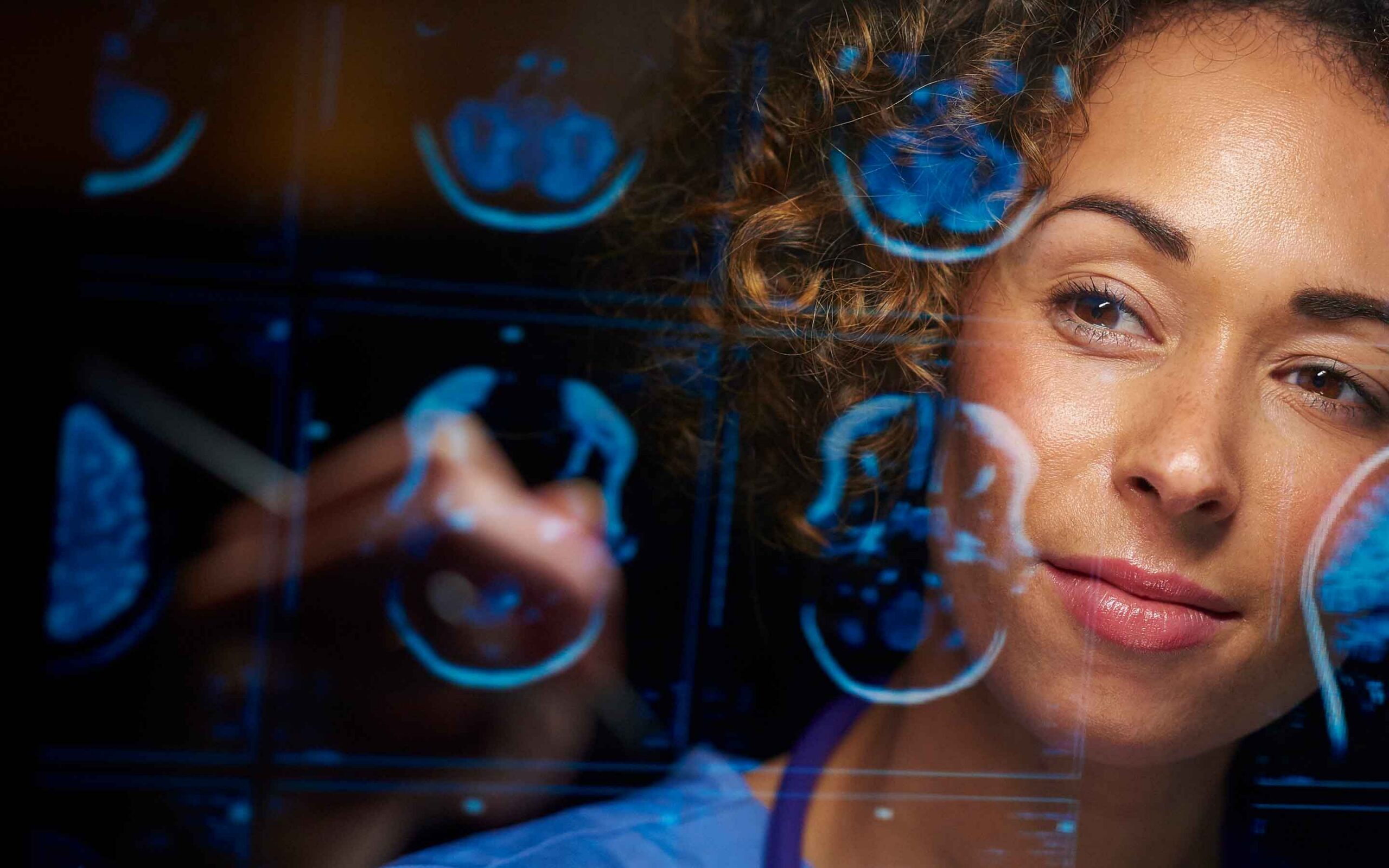 a doctor looking at brain scans