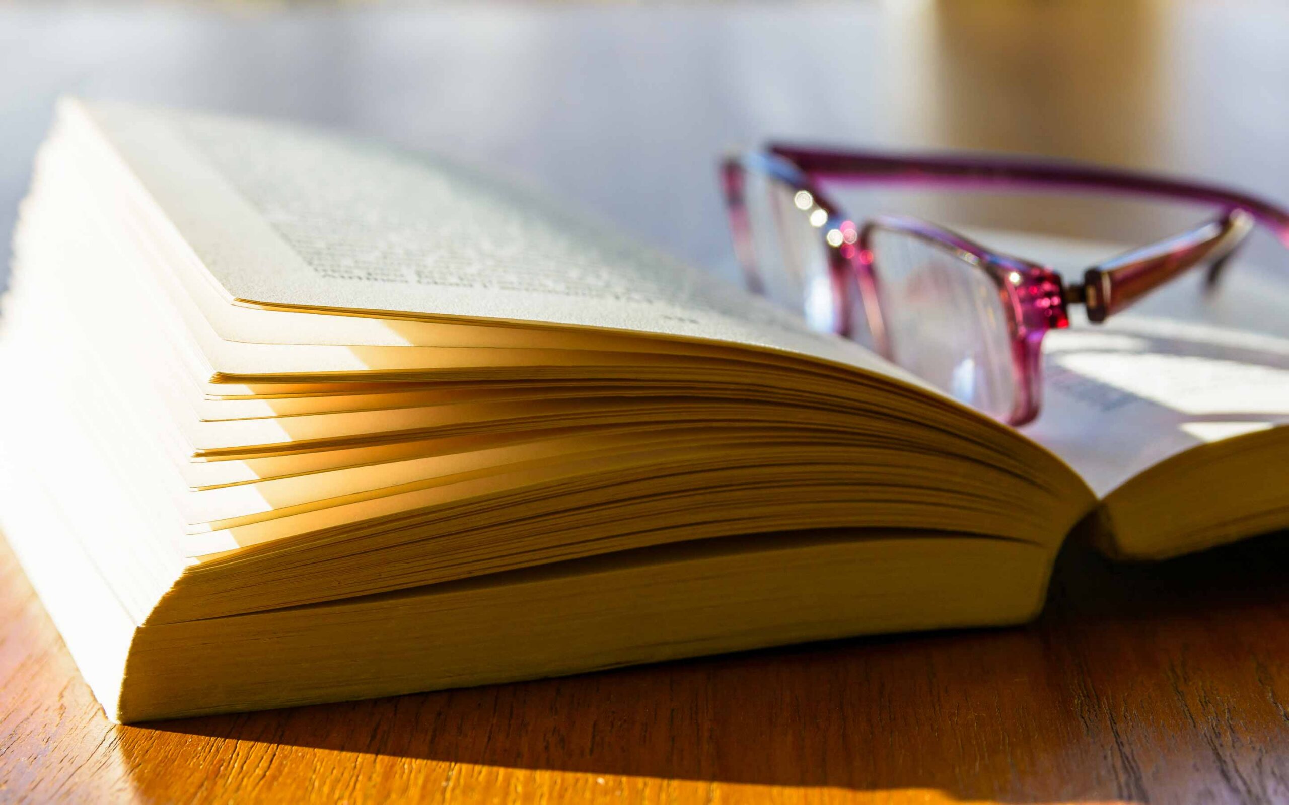 a book with reading glasses