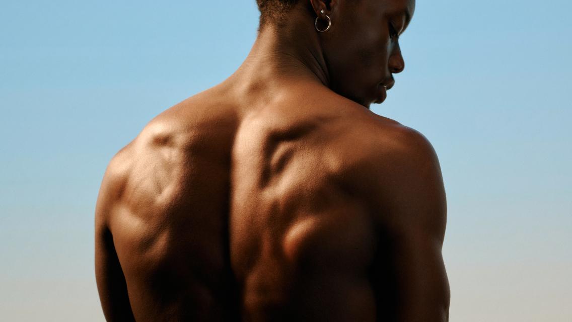 person with bare back looking away