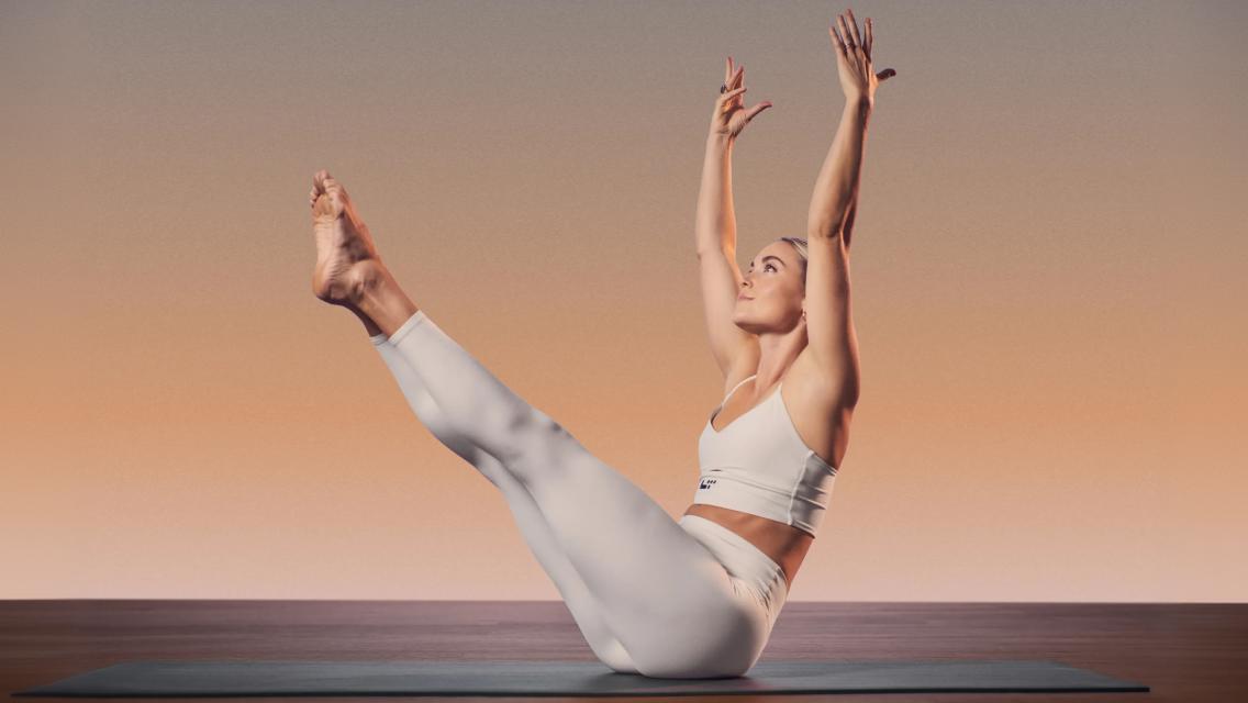 Person holding a boat pose in a MAT Pilates class at Life Time