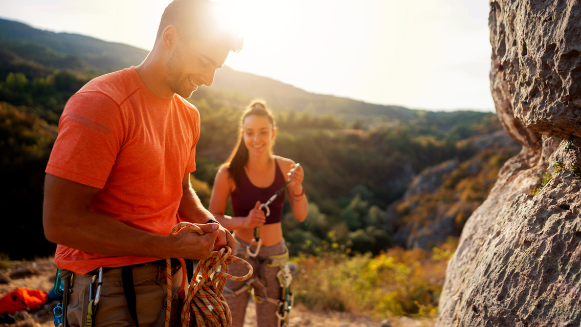 a couple prepares to go rock climbing