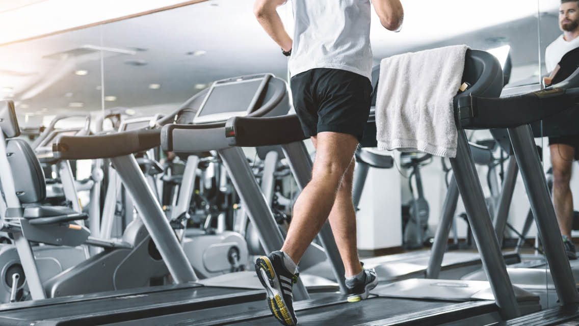 a person runs on a treadmill with a towel covering the data