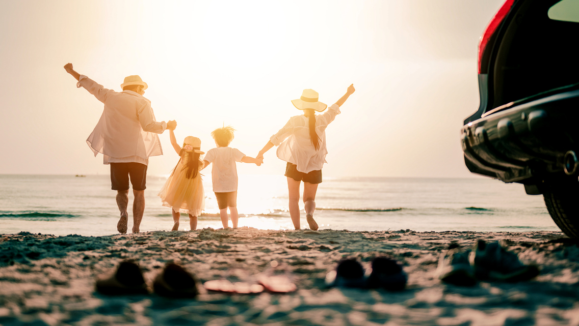 a family runs to the ocean