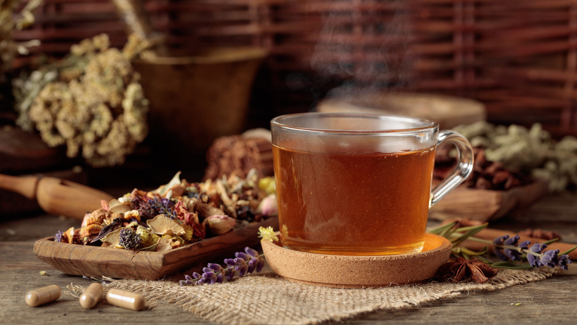 cup of anxiety supportive tea with dried herbs and mushrooms
