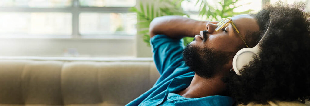a man relaxing with headphones.