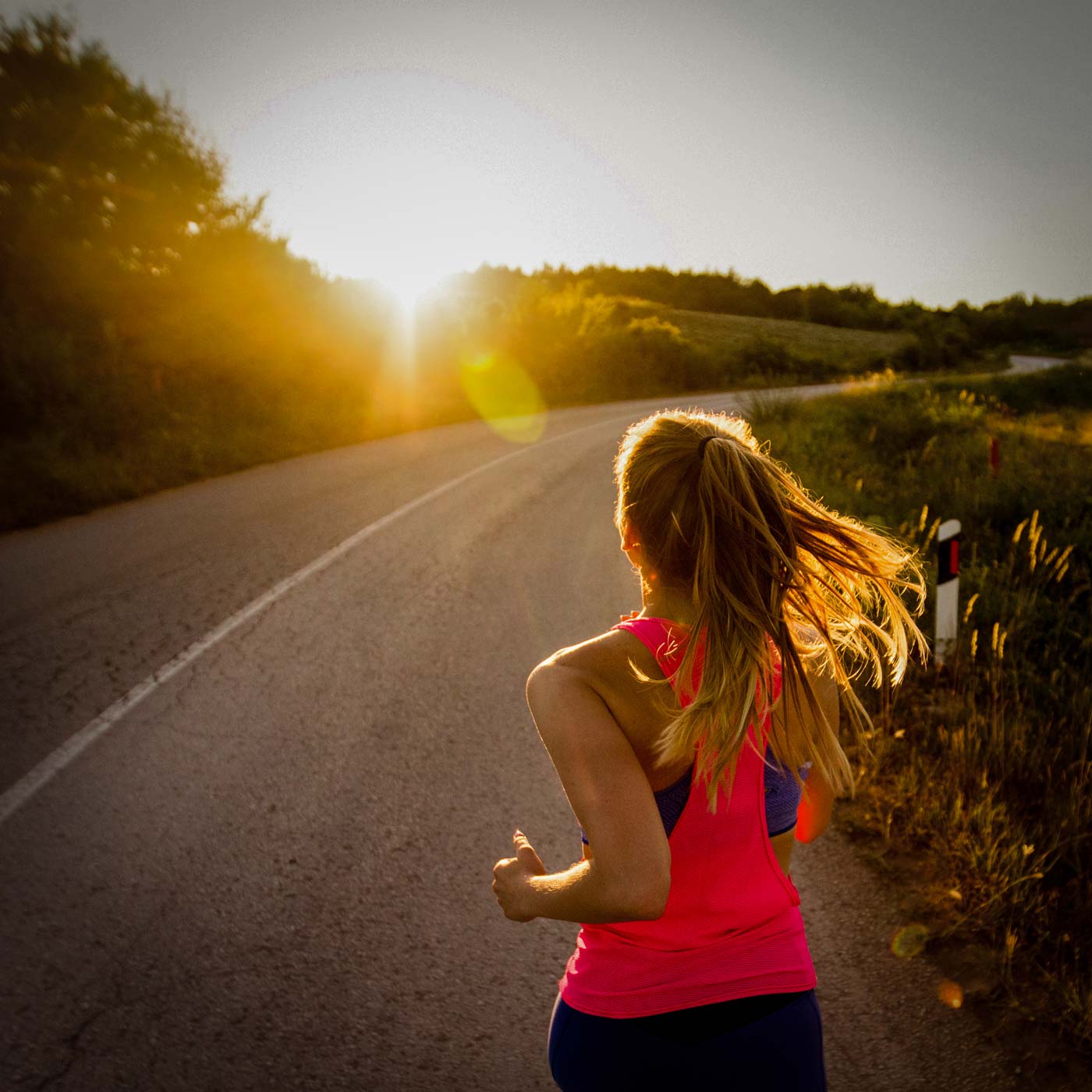 person running into sunset