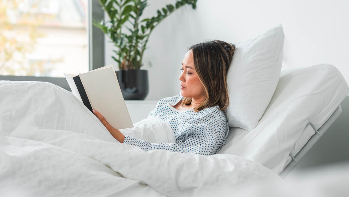 a woman reads in bed