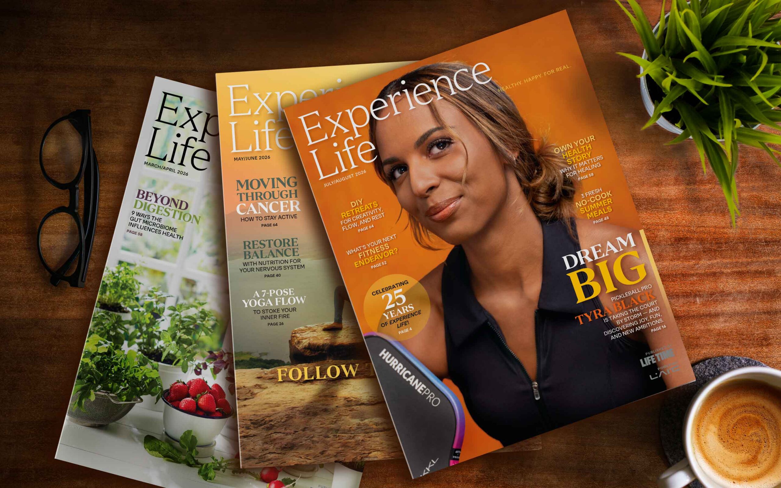 A spread of magazines with coffee and glasses