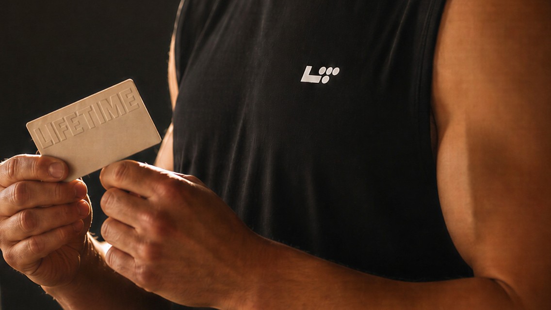 man holding life time giftcard