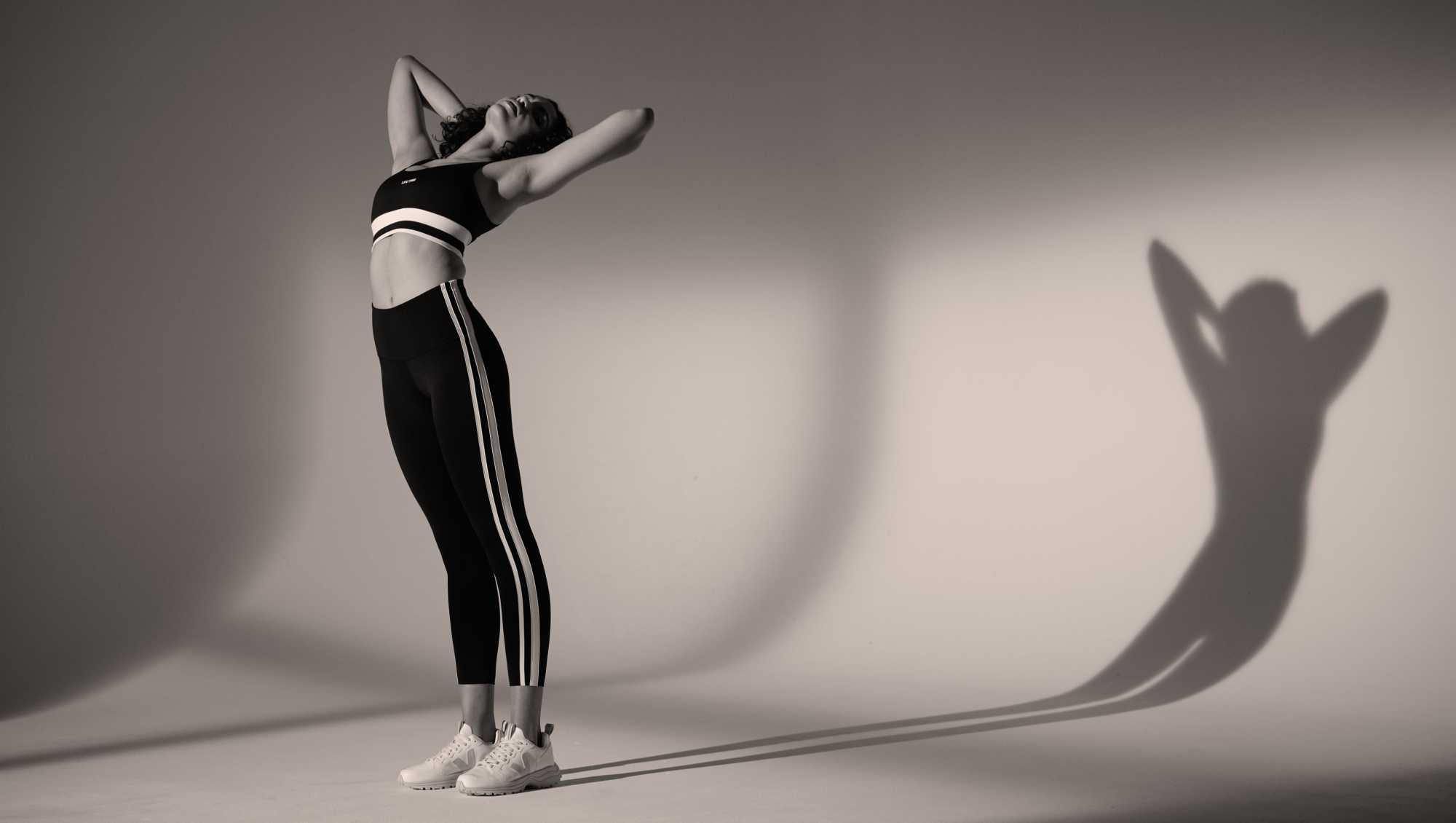 A black and white image of a woman in Life Time apparel.
