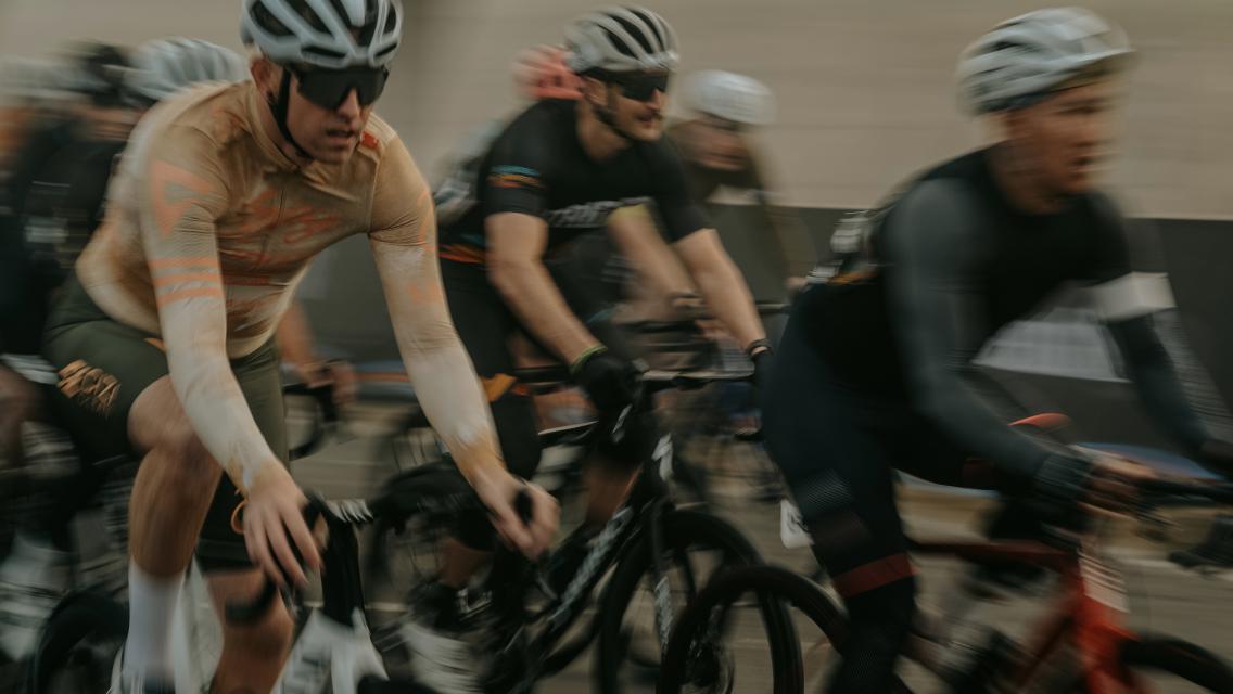 Group of cyclists biking next to each other.