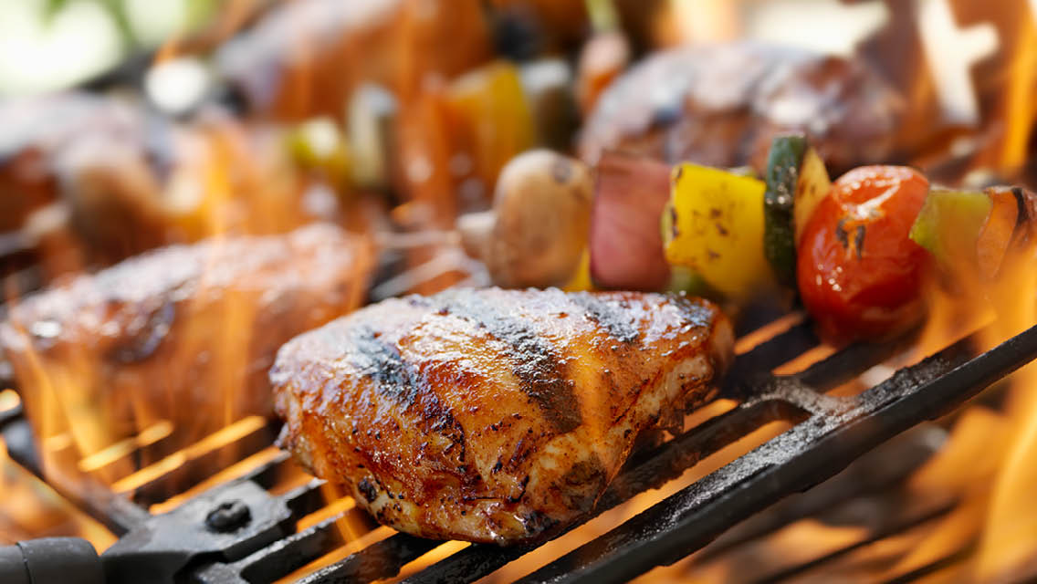 meat and veggies on a grill