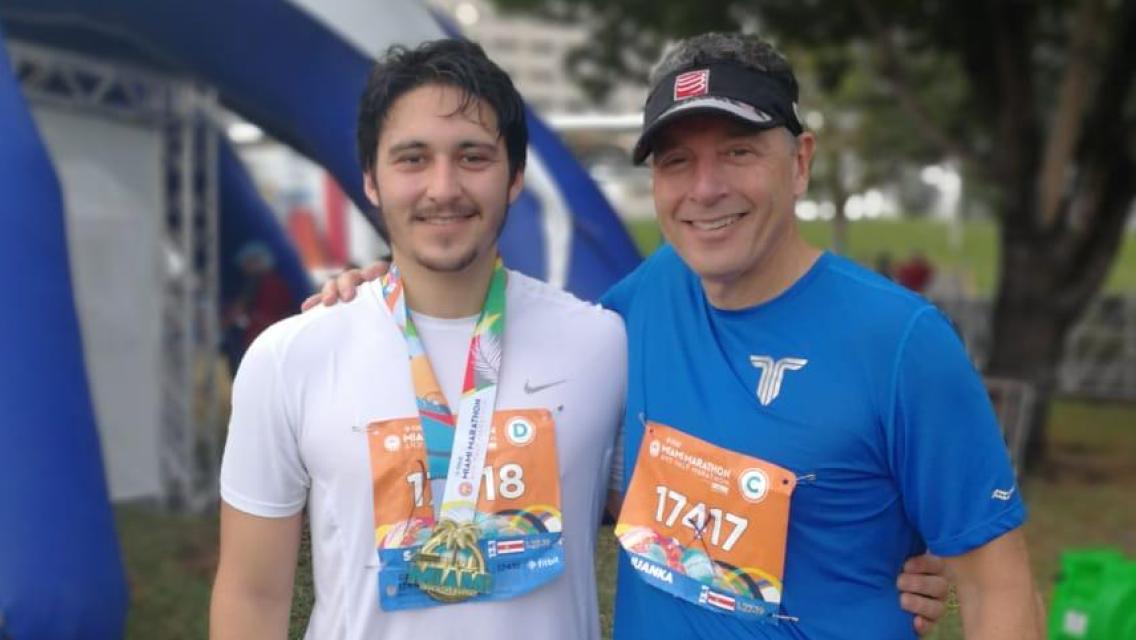 miami-marathon-runner Two men with racing bibs on.
