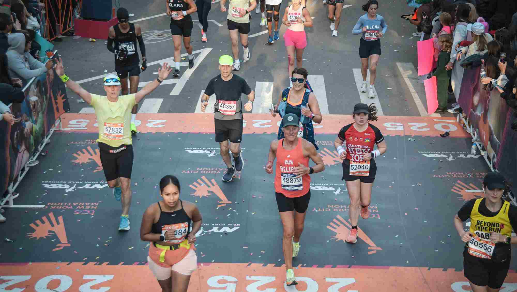 Group of runners crossing the finish line at a race.