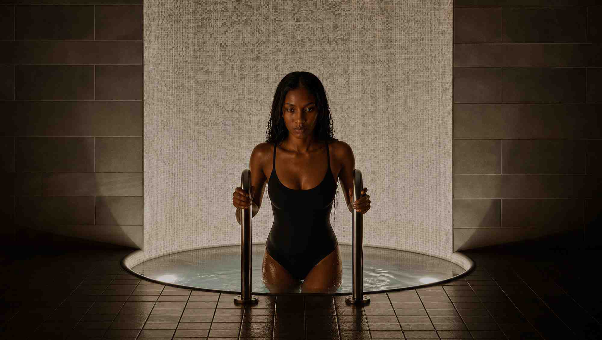 Woman stepping out of a cold plunge.