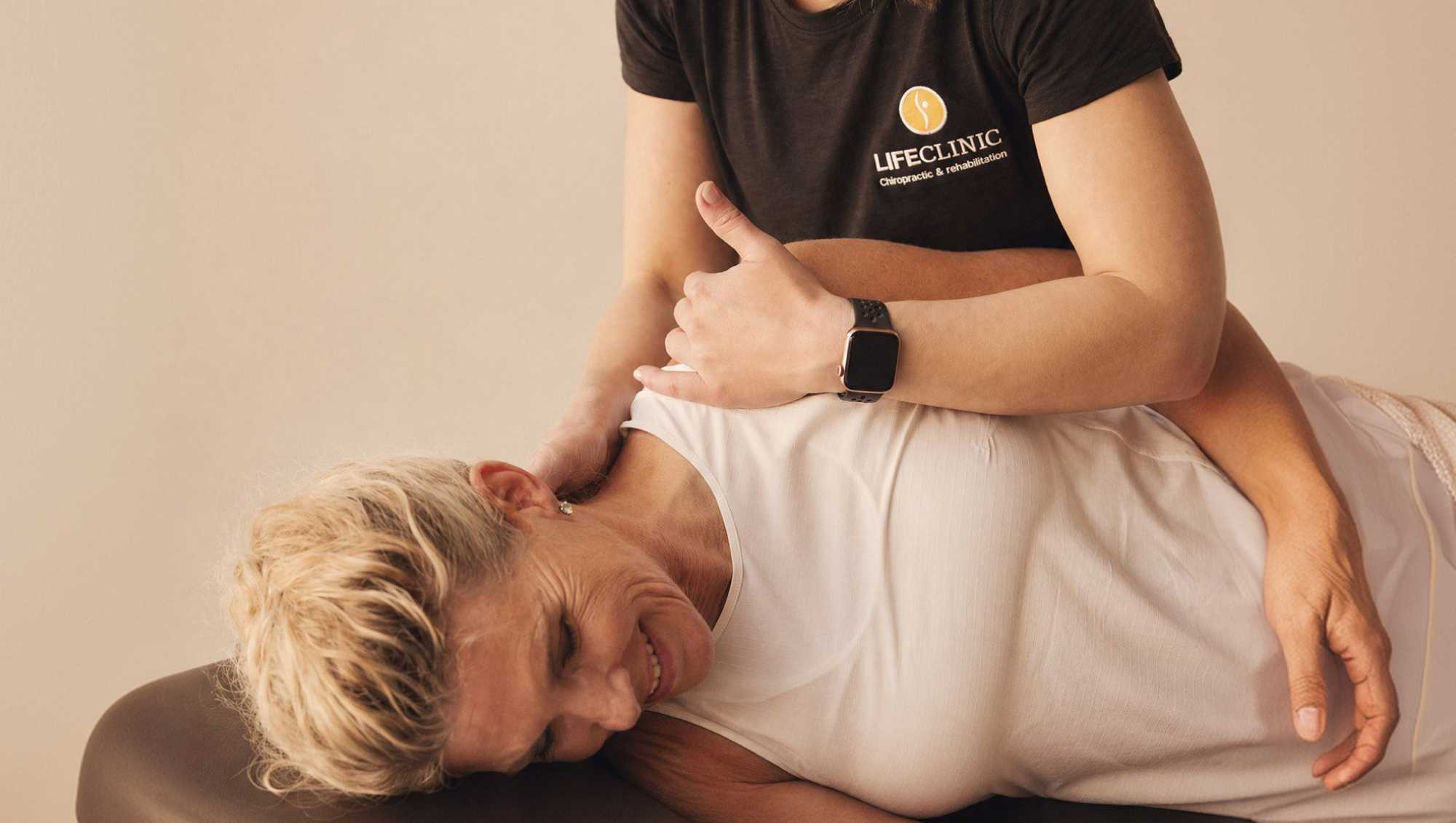 Chiropractor giving a woman an adjustment.