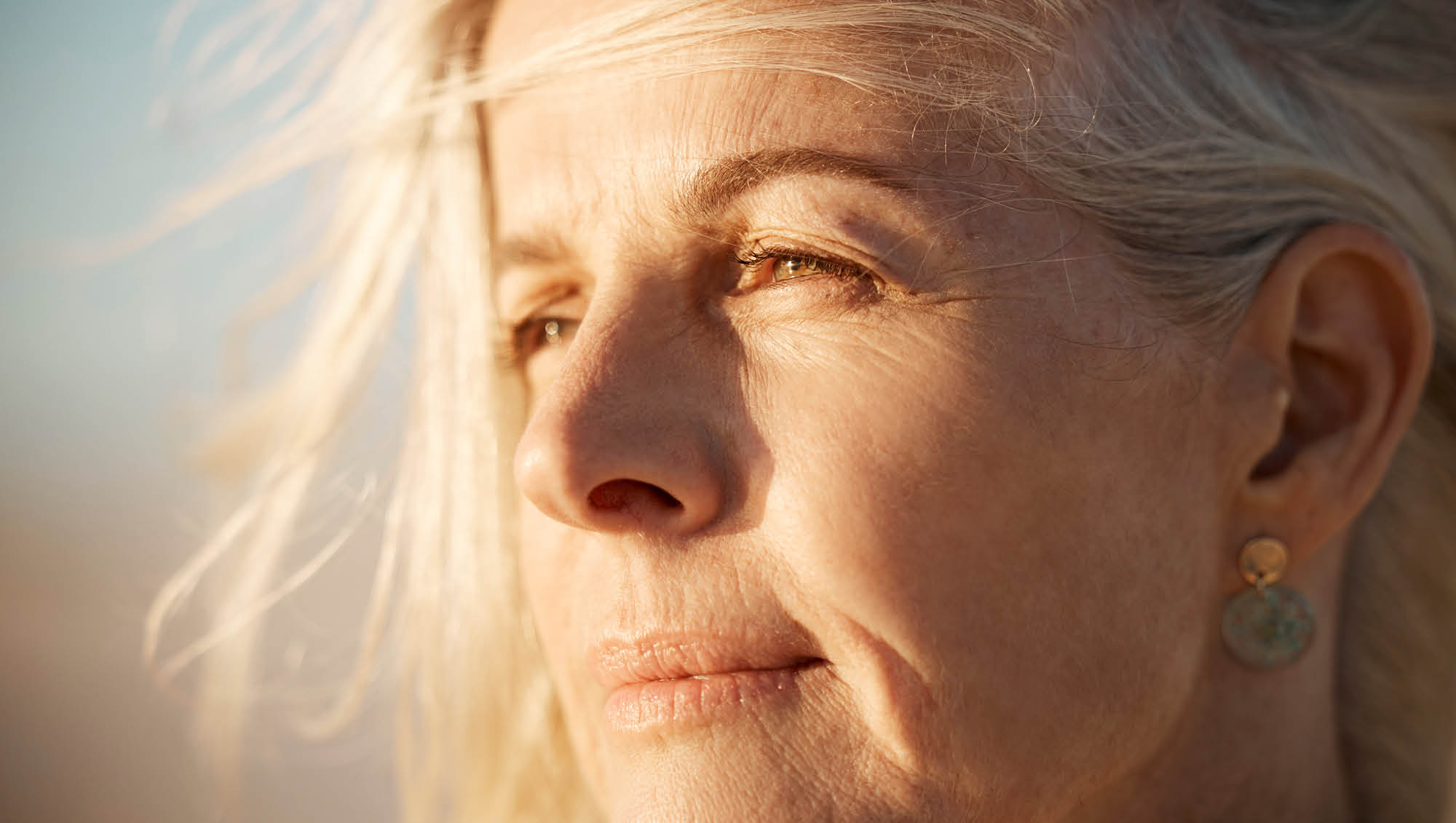 a senior woman looks off in the distance