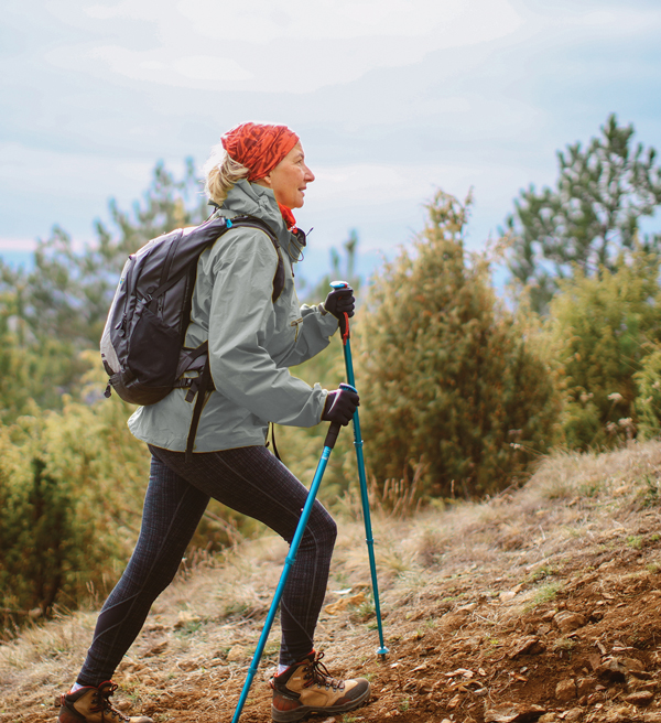 a woman hikes up a hill