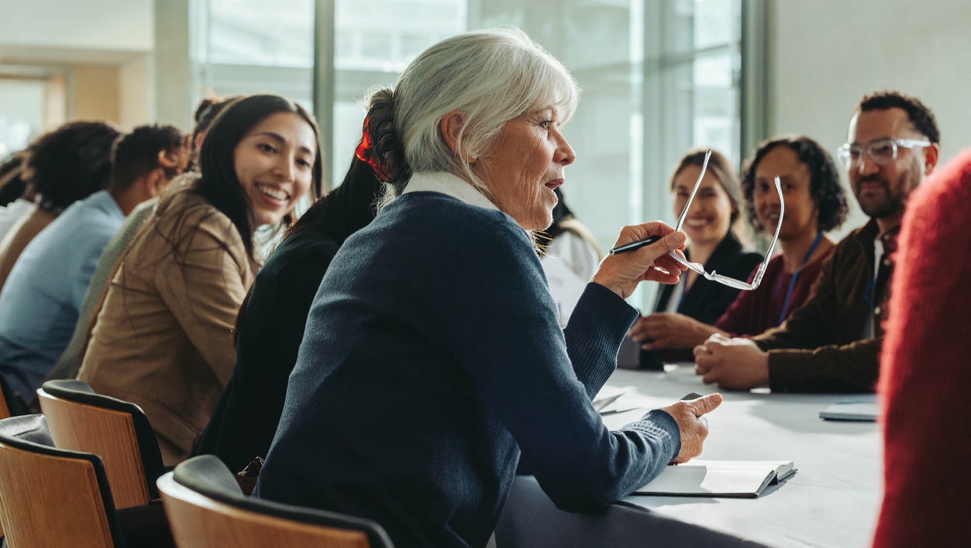 a senior woman leads a meeting
