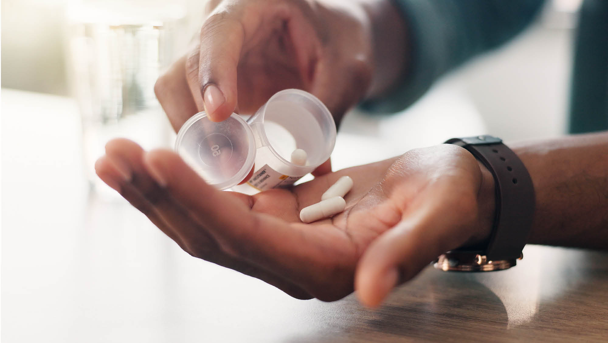 a person prepares to take pills